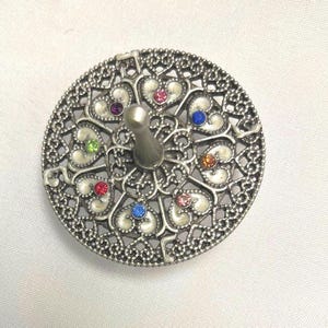 Rainbow heart dreidel on silver oxide