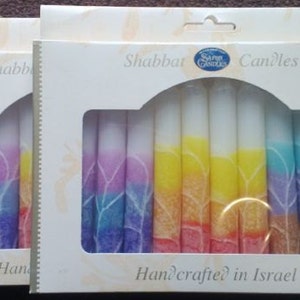 May include: A box of rainbow colored Shabbat candles with the text "Shabbat Candles" and "Handcrafted in Israel".
