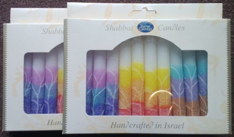 May include: A box of rainbow colored Shabbat candles with the text "Shabbat Candles" and "Handcrafted in Israel".