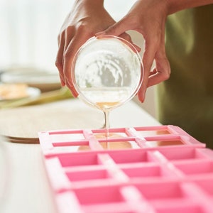 pouring soap into a soap mold with the diy soap making kit pop shop america