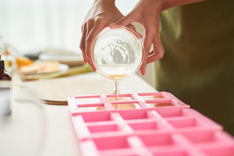 pouring soap into a soap mold with the diy soap making kit pop shop america