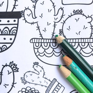 May include: A coloring page with a variety of cactus illustrations. The page is partially colored with green, blue, and light green colored pencils.