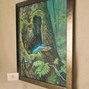 May include: A framed watercolor painting of a blue and orange lizard peeking out of a tree trunk in a lush green forest setting.
