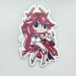 May include: A sticker featuring a chibi-style anime character with pink hair, wearing a white and red outfit with a flower design. The character has blue eyes and a cheerful expression.