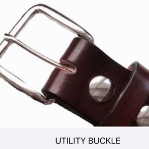 May include: Close-up of a brown leather belt with a silver utility buckle. The buckle has two small silver rivets.
