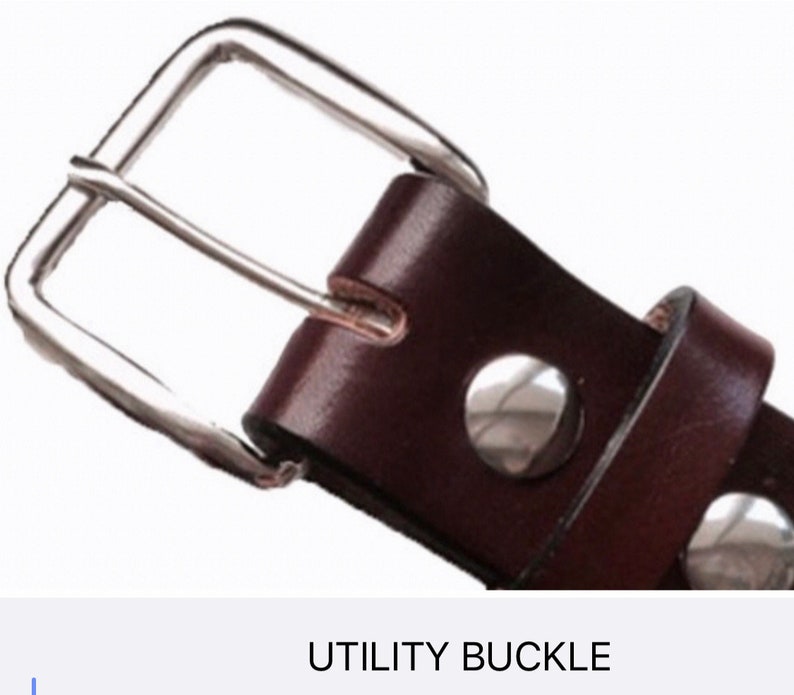 May include: Close-up of a brown leather belt with a silver utility buckle. The buckle has two small silver rivets.