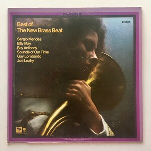 May include: A vintage vinyl record cover featuring a black and white photo of a person holding a brass instrument. The album title is "Best of The New Brass Beat" and lists the artists: Sergio Mendes, Billy May, Ray Anthony, Sounds of Our Time, Guy Lombardo, and Joe Leahy.