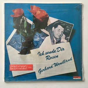 May include: A vintage vinyl record album cover featuring a photo of a man with a bouquet of red roses. The album title is "Ich sende Dir Rosen" by Gerhard Wendland.