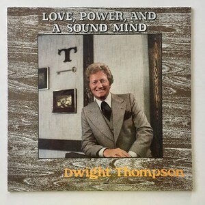 May include: A vintage vinyl record album cover featuring a man in a suit and tie. The album title is "Love, Power, and A Sound Mind" by Dwight Thompson.