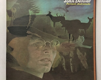 May include: A vintage vinyl record album cover featuring a portrait of John Denver with a hat and glasses. The background is a collage of animals and a sky with clouds. The album title is "Farewell Andromeda" by John Denver.