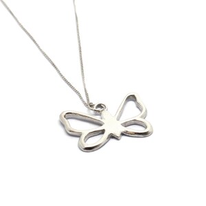 May include: A silver necklace with a delicate butterfly pendant. The butterfly is cut out of the metal, creating a delicate and airy look.