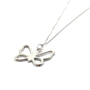 May include: A silver necklace with a delicate butterfly pendant. The butterfly is a cutout design, creating a delicate and airy look.