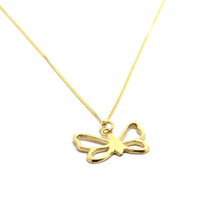 May include: A gold chain necklace with a delicate butterfly pendant.