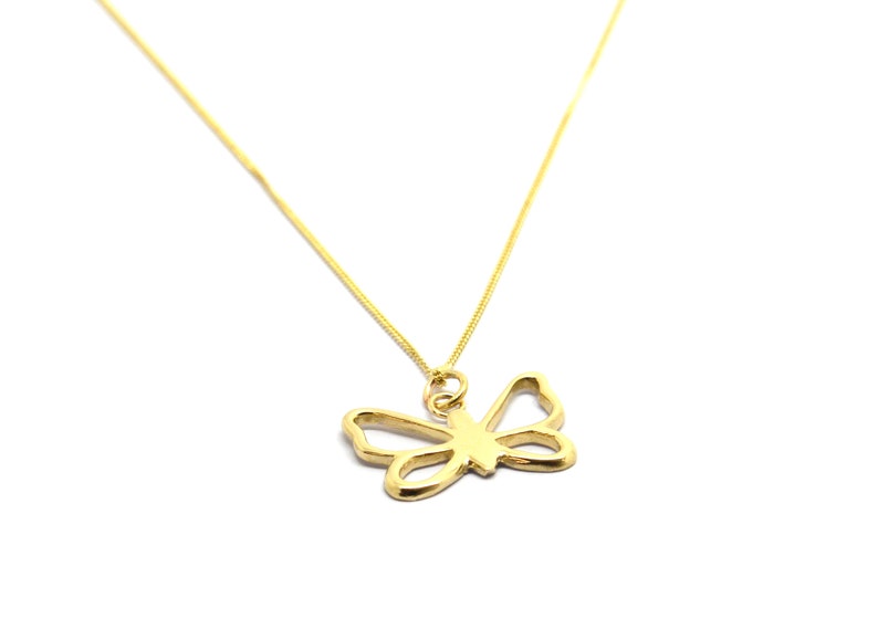 May include: A gold chain necklace with a delicate butterfly pendant.
