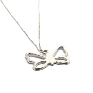 May include: A silver necklace with a delicate butterfly pendant. The butterfly is a simple outline with no details.