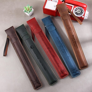May include: Five leather carrying cases with different engraved messages. The cases are in various colors, including brown, red, blue, and green. The text on the cases includes "Brad Garner, Class of 2024", "You are the best driver I know", "Groove is King - Alex Van Halen", and "You are the best driver I know".