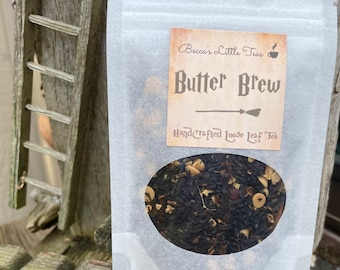 May include: A white resealable pouch with a label that reads "Becca's Little Teas" and "Butter Brew Hand-Crafted Loose Leaf Tea". The pouch contains loose leaf tea.