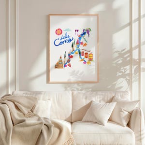 a living room with a white couch and a poster on the wall