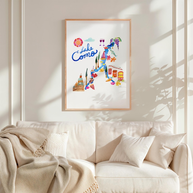 a living room with a white couch and a poster on the wall