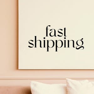 a picture hanging on a wall above a bed