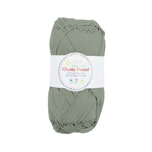 May include: A skein of sage green chunky thread, wrapped with a white label. The label reads "Chunky Thread" by Lori Holt of Bee in my Bonnet, with a floral design and the text "100% Cotton". Ideal for knitting and crochet projects.