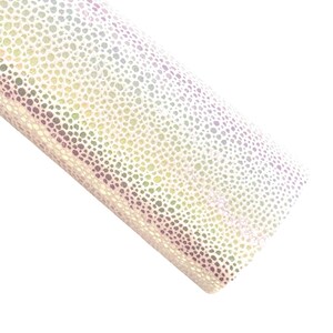 May include: A roll of iridescent faux leather fabric. The material has a speckled pattern with a mix of colors, including white, yellow, green, and purple. The fabric is rolled up, showing its texture and sheen.