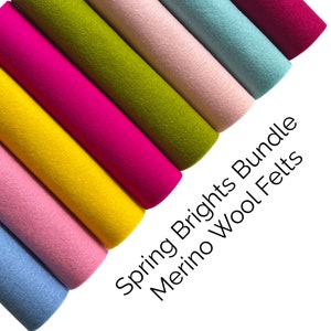 May include: A bundle of 8 different coloured merino wool felts in a rainbow colour scheme. The colours are pink, yellow, light blue, green, light pink, blue, and red. The felts are arranged in a fan shape and the text "Spring Brights Bundle Merino Wool Felts" is written below the felts.
