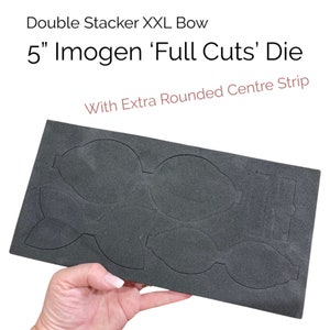 May include: A black die cutting mat with five cutouts for a 5 inch Imogen 'Full Cuts' bow. The die is designed for a double stacker XXL bow with an extra rounded center strip.