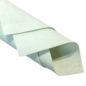 May include: A roll of light green felt fabric. The fabric is folded in thirds and the edges are visible.