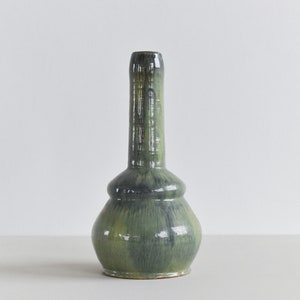 May include: A green and blue ceramic vase with a bulbous body and a long, narrow neck.