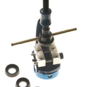 May include: A blue metal watch case press with a brass handle and five different sized black rubber rings.