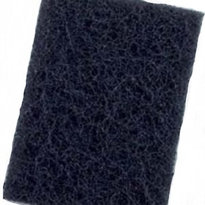 May include: A black, rectangular, sponge-like material with a rough texture. It is a filter for a water filtration system.
