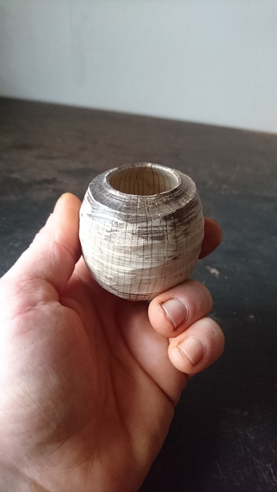 A hand-carved textured oak vessel that's more tactile sculpture than vessel — the kind of object you pick up, turn over, and can't put down.