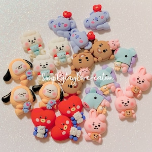 May include: A collection of colorful, cartoon character charms featuring characters from the popular K-pop group BTS. The charms are made of polymer clay and are perfect for adding a touch of personality to your jewelry, bags, or other accessories.