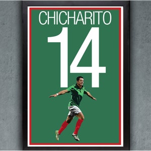 May include: A framed poster featuring the name "CHICHARITO" above the number "14" in white. The poster has a green background with a soccer player in a green jersey and red socks. The frame is black.
