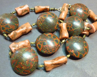 Necklace of African trade brass beads with unique polymer beads by Karen Murphy.  27"