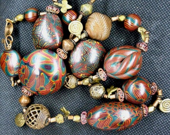 Necklace of African trade lost wax brass beads with unique polymer beads by Karen Murphy.  29"