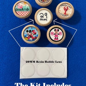 May include: Unfinished wooden draw pull kits featuring circular wooden bezels with various graphic inserts, including cartoon characters and text. A central knob displays 29 mm, and a sheet of six clear 29MM resin bubble lens covers is included.