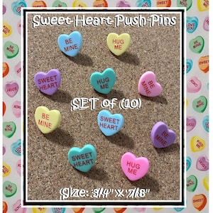 May include: A set of 10 heart-shaped push pins in various colors, including pink, blue, yellow, and purple. Each pin features a different sweet message, such as "Sweet Heart", "Hug Me", and "Be Mine". The pins are 3/4 inch by 7/8 inch.