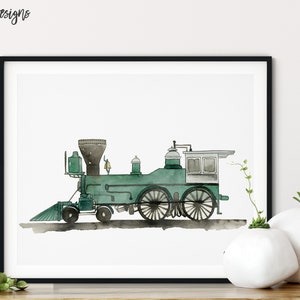 May include: Watercolor print of a vintage green steam train in a black frame. The train features a detailed design with black wheels and a smokestack. The artwork is signed "kelseymDesigns" in the top left corner. The print is displayed on a white background.