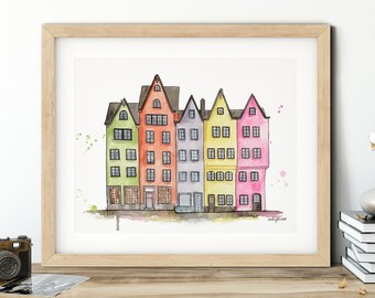 May include: Watercolor painting of a row of colorful houses with pointed roofs. The houses are painted in shades of green, orange, purple, yellow, and pink. The painting is framed in a light wood frame.