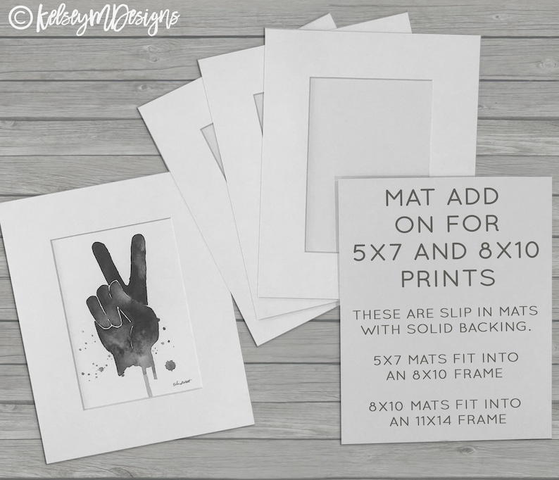 May include: Four white mat boards with cutouts for 5x7 and 8x10 prints. The text on the mat board reads "MAT ADD ON FOR 5X7 AND 8X10 PRINTS THESE ARE SLIP IN MATS WITH SOLID BACKING. 5X7 MATS FIT INTO AN 8X10 FRAME 8X10 MATS FIT INTO AN 11X14 FRAME"