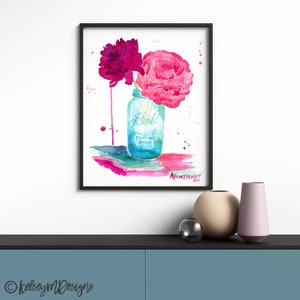 May include: Watercolor painting of pink and purple flowers in a blue Ball mason jar with the words "Perfect Mason" on the jar. The painting has a white background with watercolor splatters in pink, purple, and green.