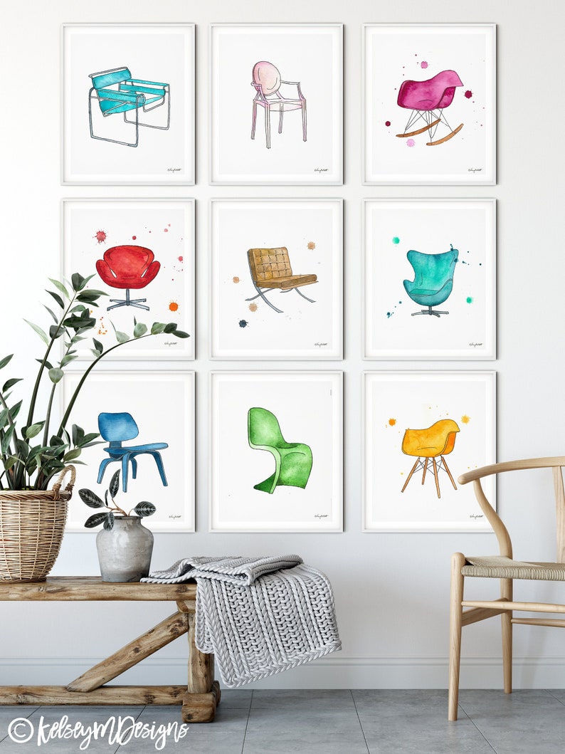 May include: Nine watercolor illustrations of different chairs, each framed in a white frame and hung on a white wall. The chairs are in various colors, including blue, green, red, yellow, and pink.