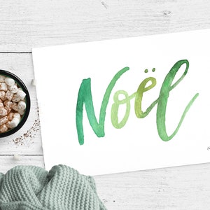 May include: A watercolor painting of the word "No&euml;l" in green and yellow hues on a white background. The word is written in a cursive script.