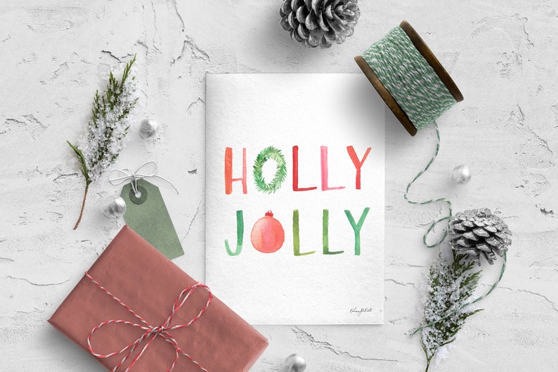 May include: A watercolor Christmas card with the words "HOLLY JOLLY" in green, red, and pink. The "O" in "HOLLY" is a green wreath and the "O" in "JOLLY" is a red ornament.
