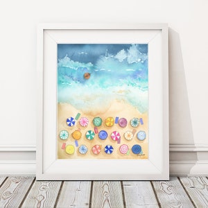 May include: A watercolour painting of a beach scene with colourful umbrellas and a small boat in the ocean. The painting is framed in a white frame.