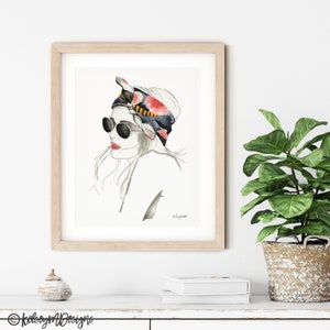 May include: A watercolor illustration of a woman with a floral patterned headscarf and sunglasses. The woman is looking off to the side and has a soft, dreamy expression.
