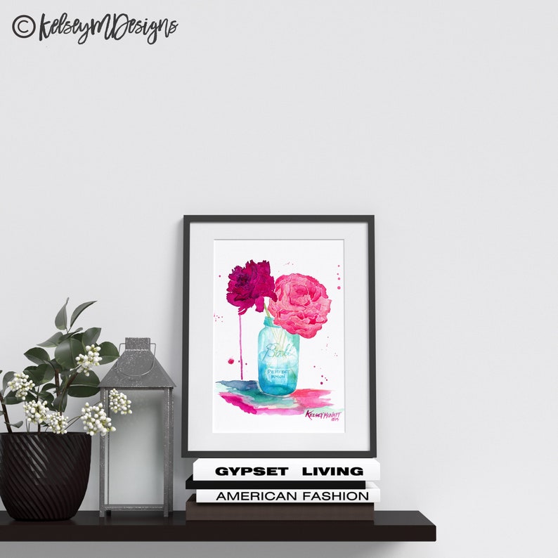 May include: Watercolor painting of pink and magenta peonies in a blue mason jar with the word "Pickle" on the jar. The painting has a white background with watercolor splatters.
