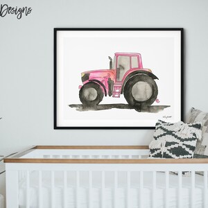 May include: A watercolor painting of a pink tractor on a white background. The tractor has black wheels and a black exhaust pipe. The painting is framed in a black frame.